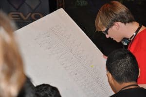 tournament volunteer reading a 256-man bracket at Evolution Fighting Game Tournament 2010