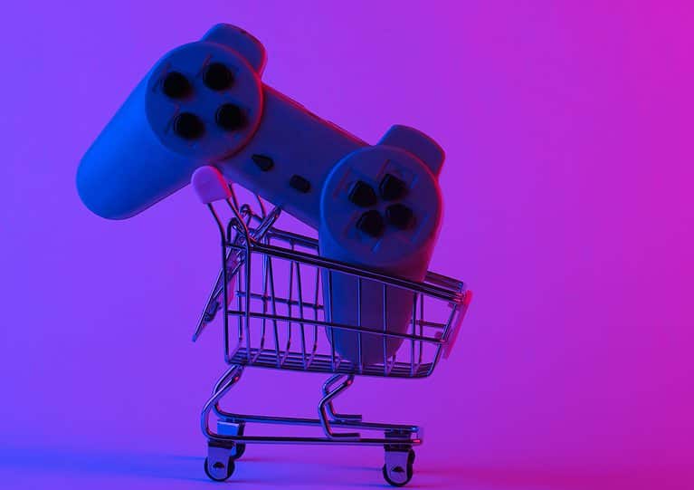 Shoping trolley with retro gamepad in trendy neon light. Gradient pink-blue glow. Concept art. Retro 80s. Minimalism